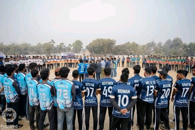 Cricket players in team jerseys standing in a circle on the field