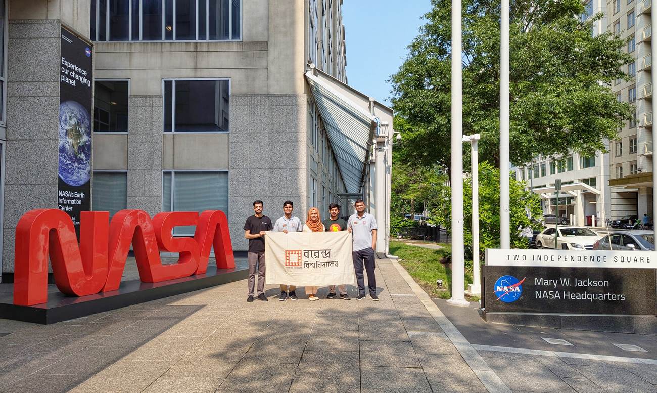 Team Voyagers with the Varendra University flag outside NASA Headquarters