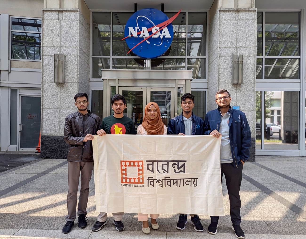 At the NASA Headquarters entrance with the Varendra University flag
