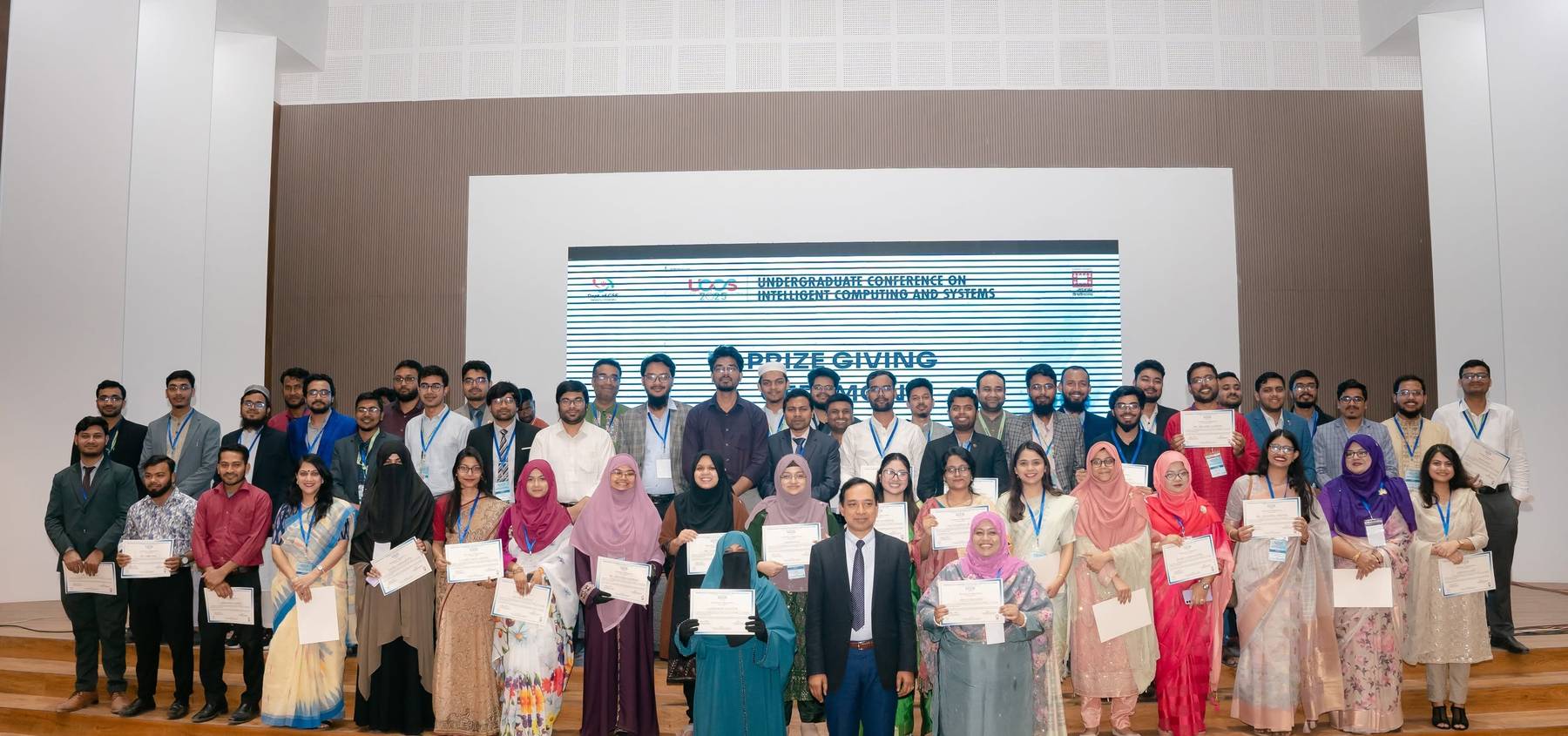 Participants holding certificates at the UCICS 2025 prize giving ceremony